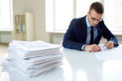 Man working on a desk with paperwork